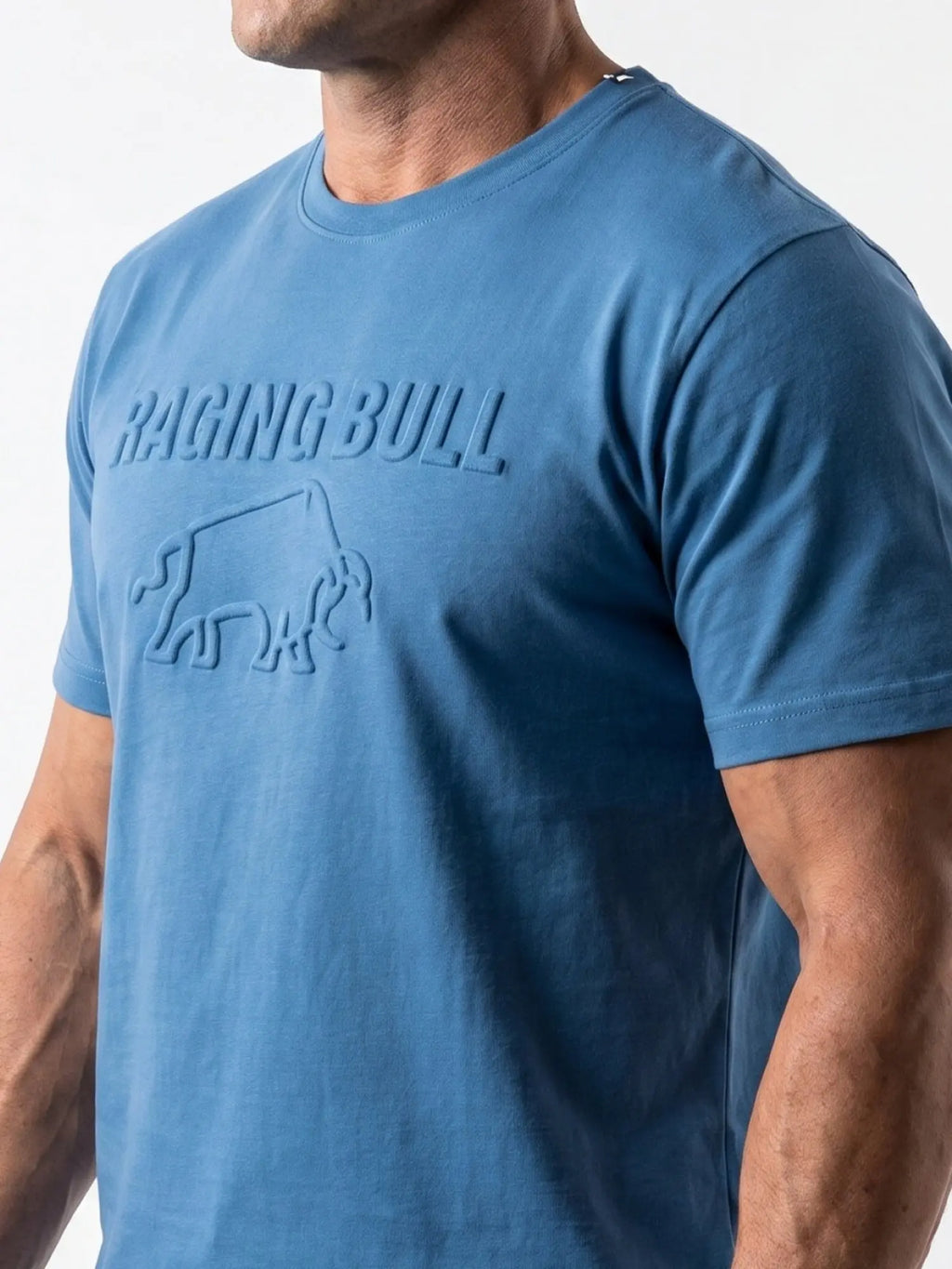 Man wearing a Raging Bull 3D emboss graphic t-shirt in denim, front. 