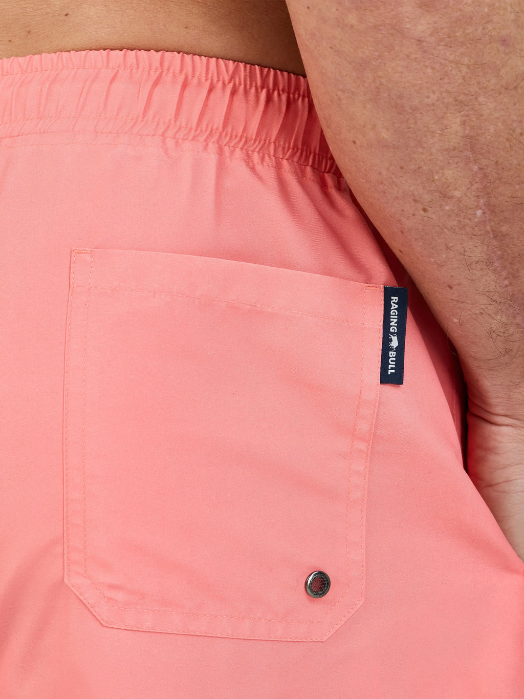 Man wearing Raging Bull Swim Shorts - Coral, back detail. 