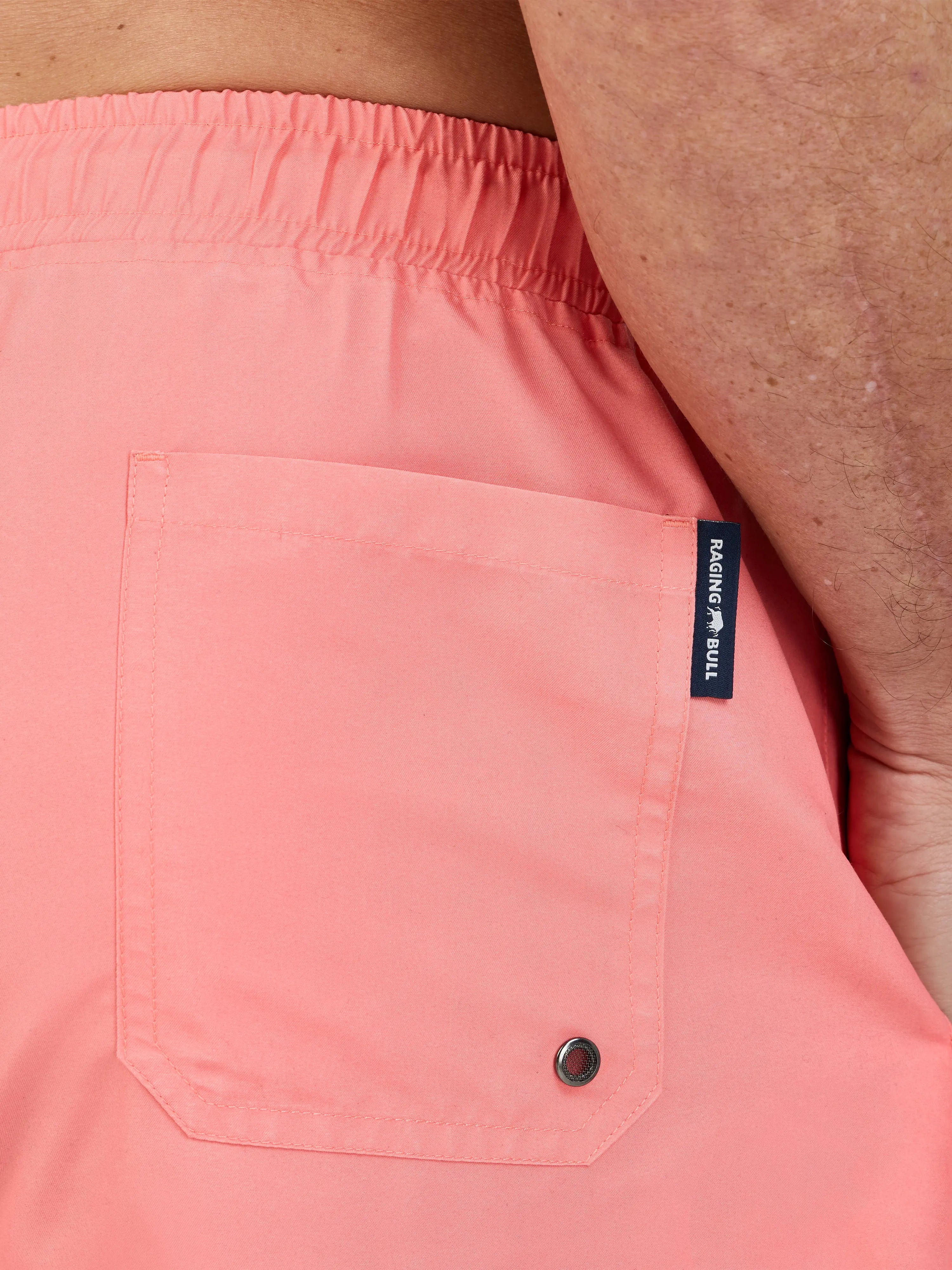Man wearing Raging Bull Swim Shorts - Coral, back detail. 