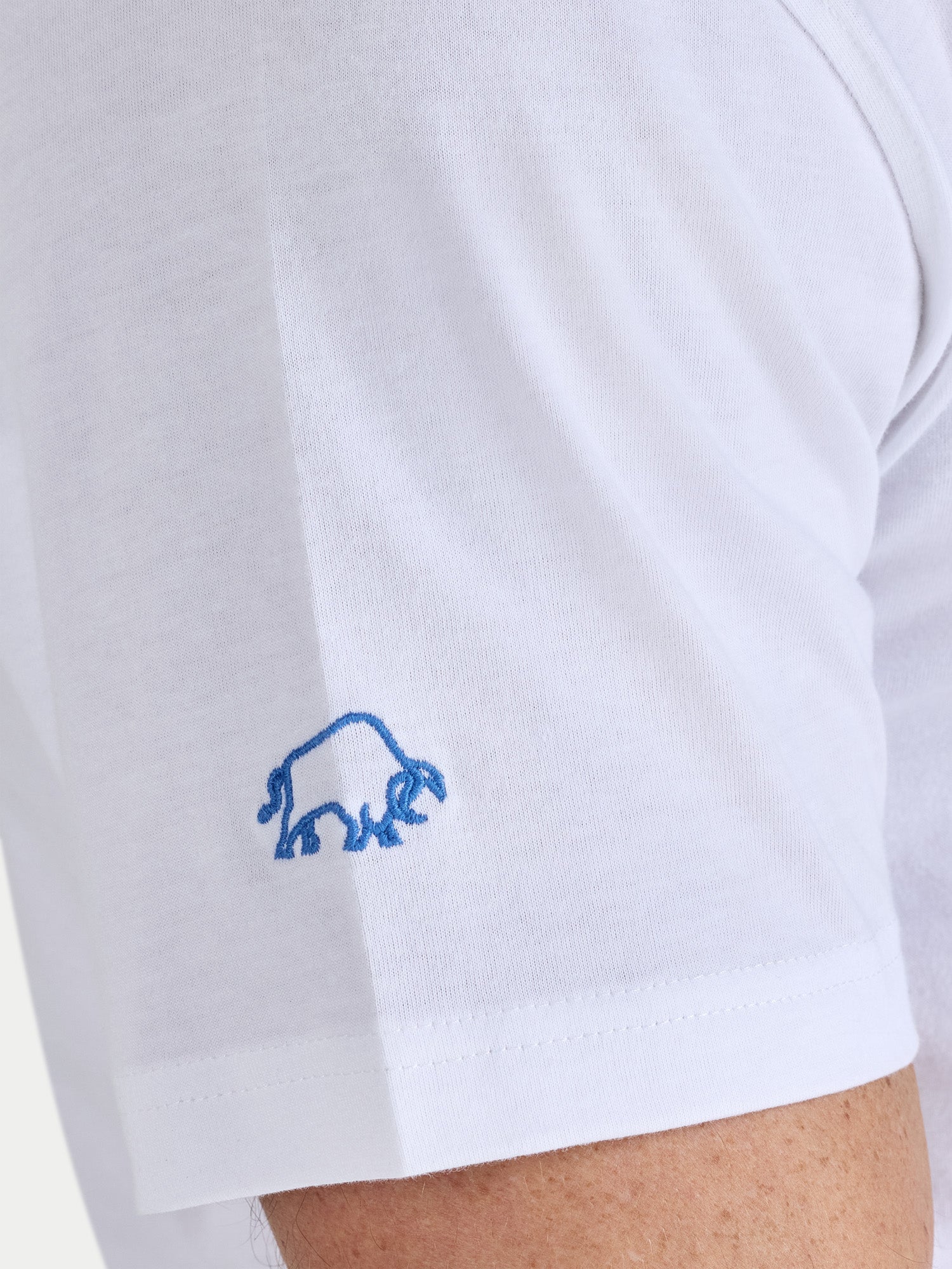 White shirt with a blue logo on the sleeve