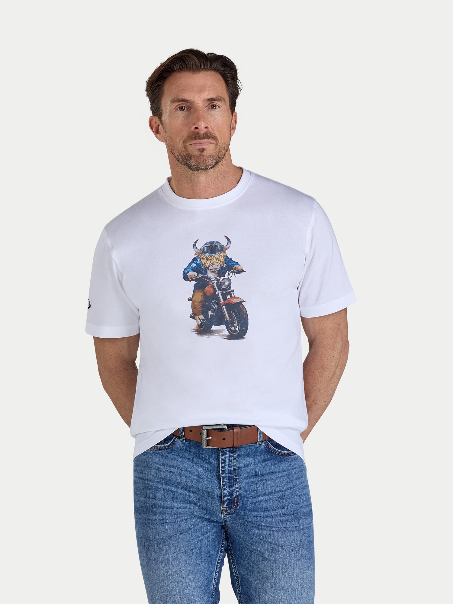 Man wearing a white t-shirt with a graphic design on a plain background