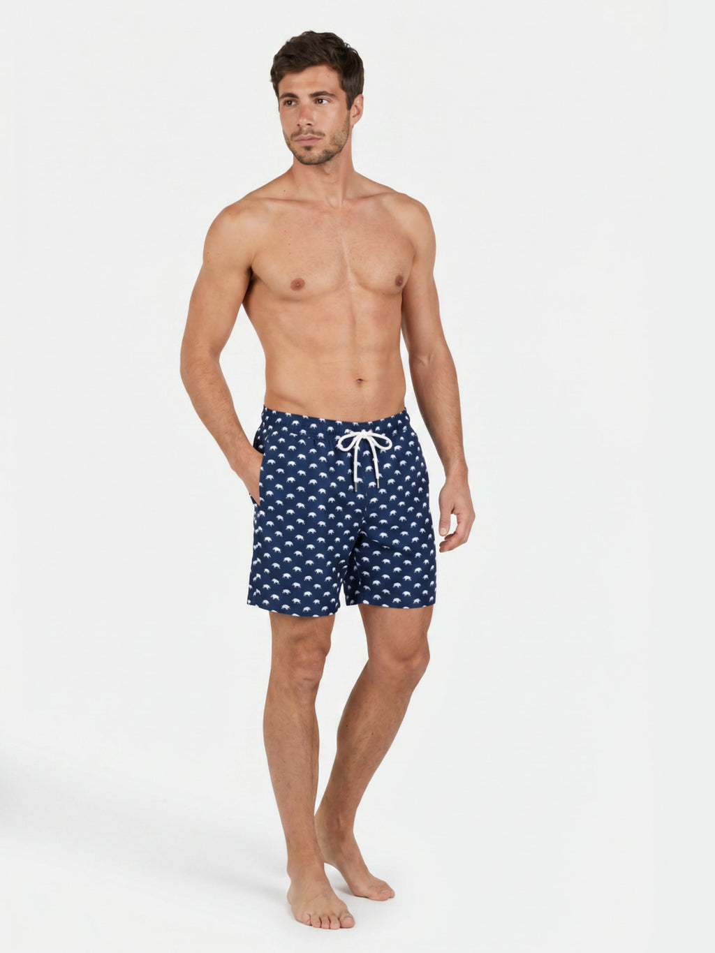 Man wearing Raging Bull Bull print swim shorts navy on white background. 