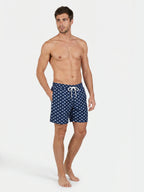 Man wearing Raging Bull Bull print swim shorts navy on white background. 