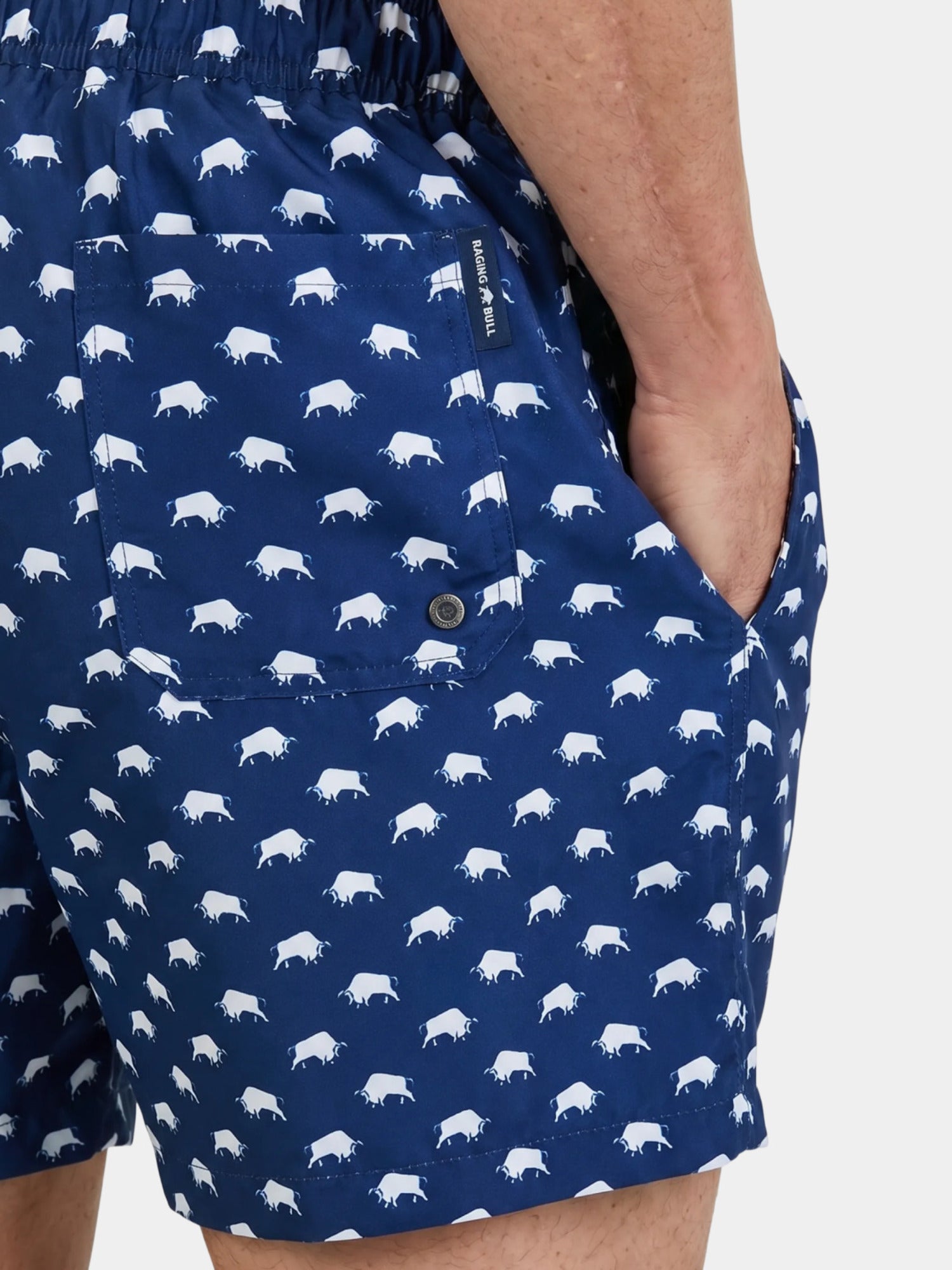 Man wearing Raging Bull Bull print swim shorts navy, back pocket detail. 