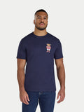 Man wearing a navy blue t-shirt with a small graphic on a white background