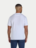 Man wearing a plain white t-shirt on a light gray background
