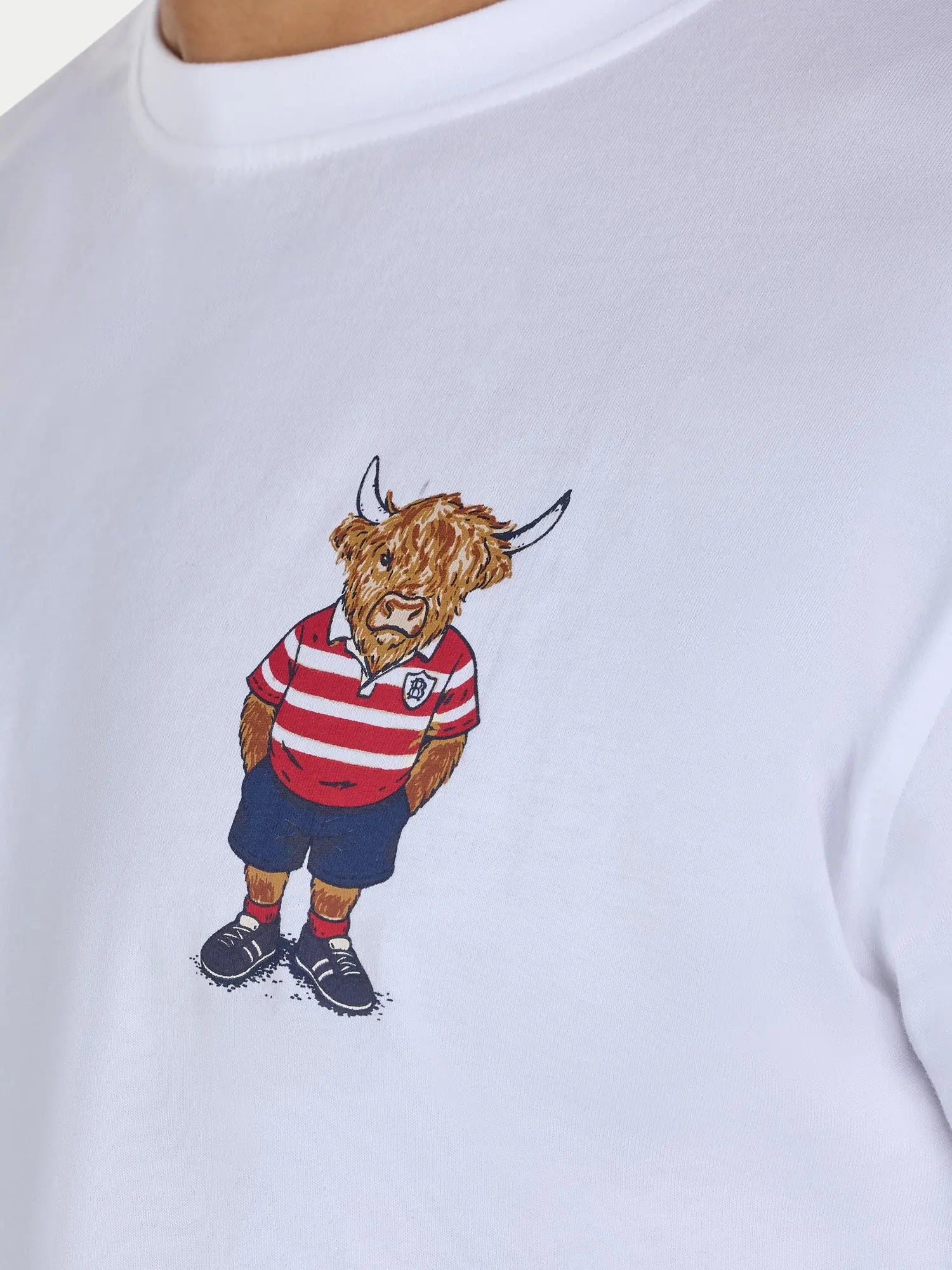 White sweatshirt with a cartoon bull wearing a red and white striped shirt and blue shorts on a white background.