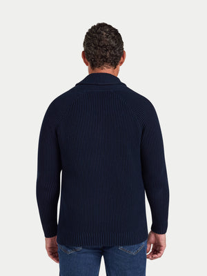 Man wearing a navy ribbed sweater on a white background