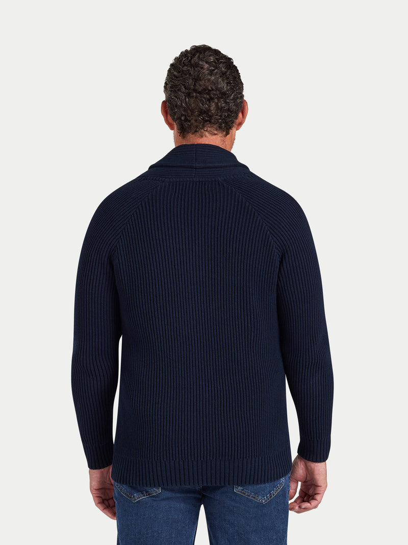 Man wearing a navy ribbed sweater on a white background