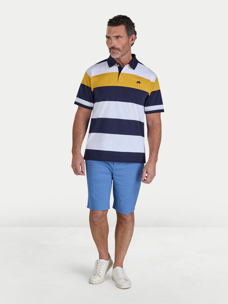 Man wearing a striped polo shirt and blue shorts on a white background
