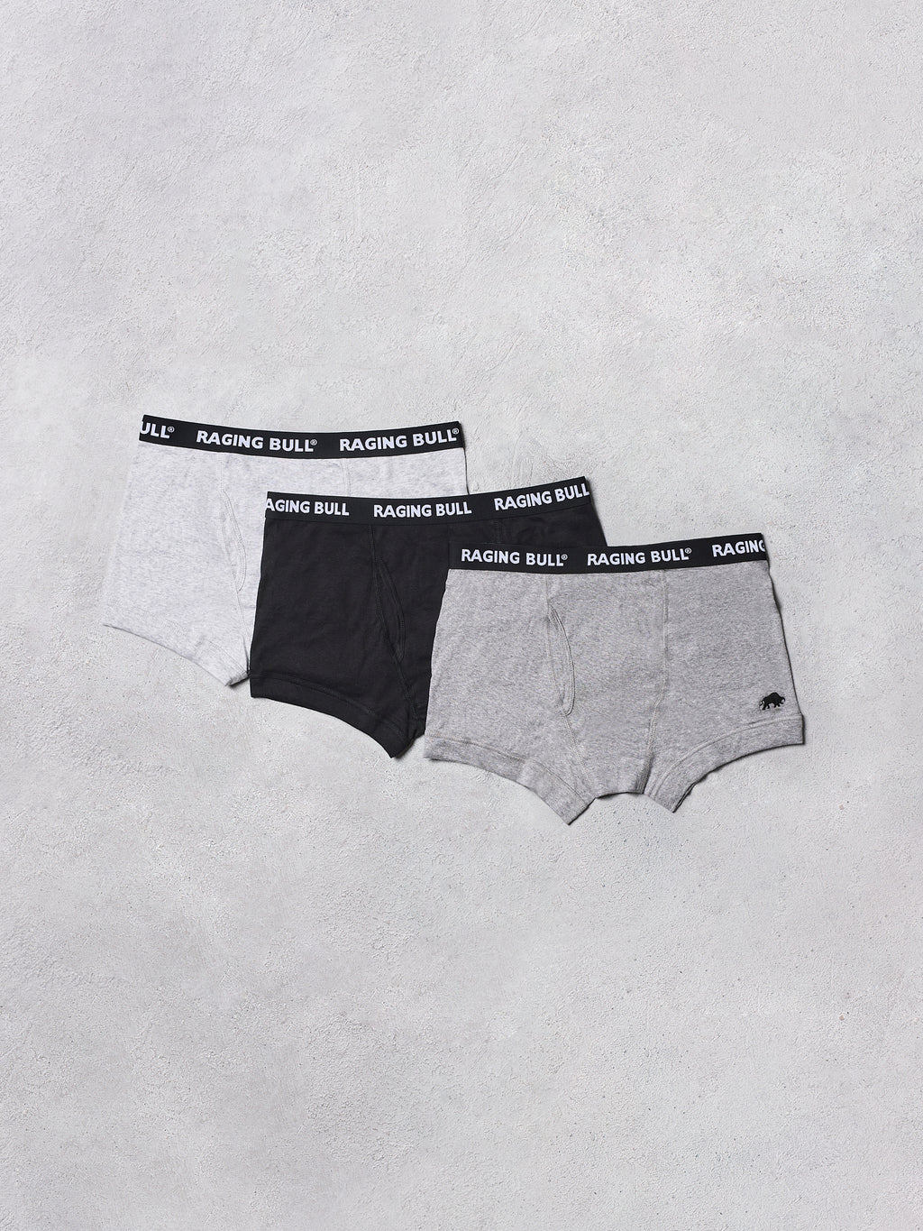 Three pairs of Raging Bull underwear on a light gray background