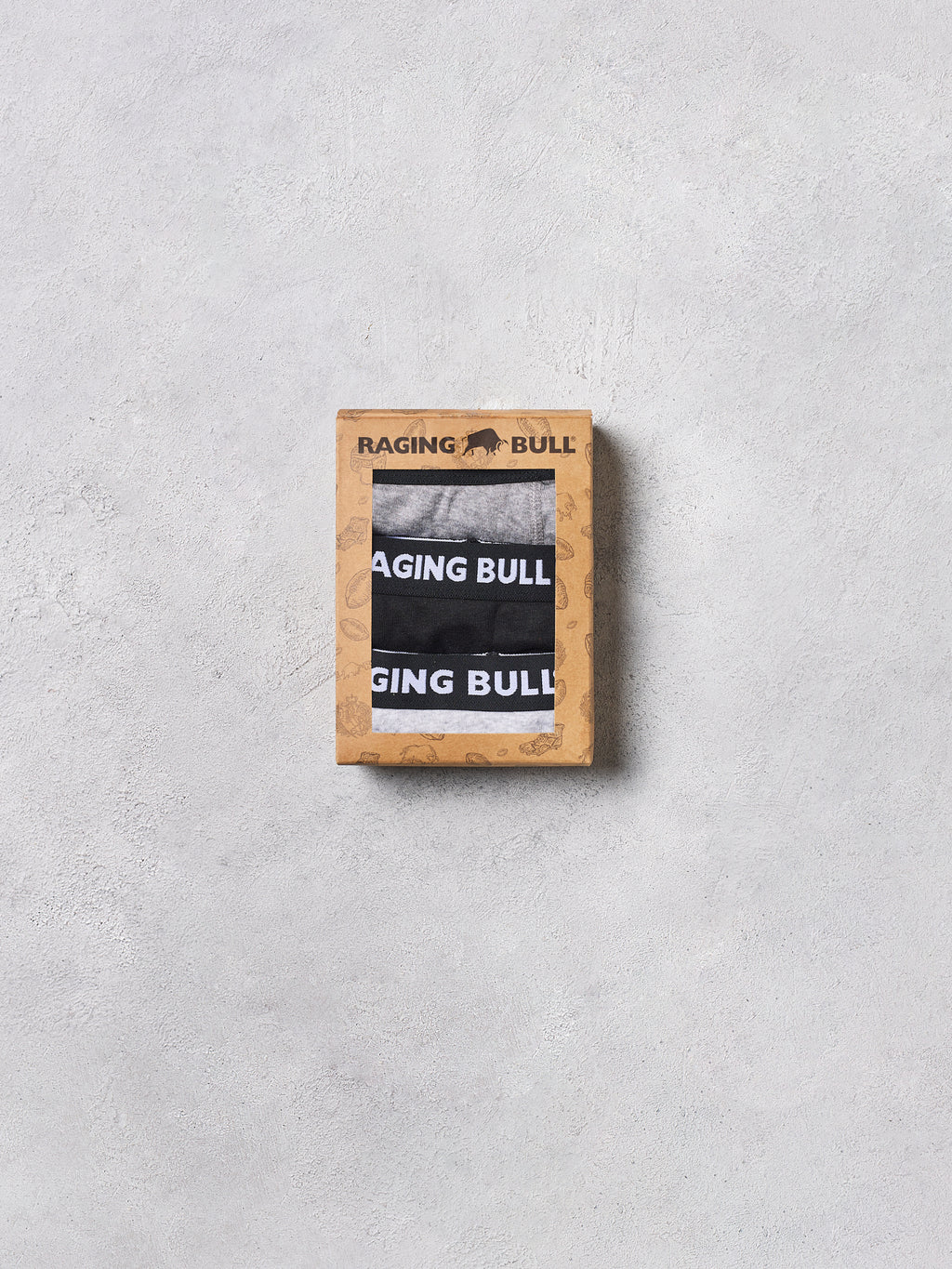 Raging Bull boxer briefs in a wooden box on a light gray background