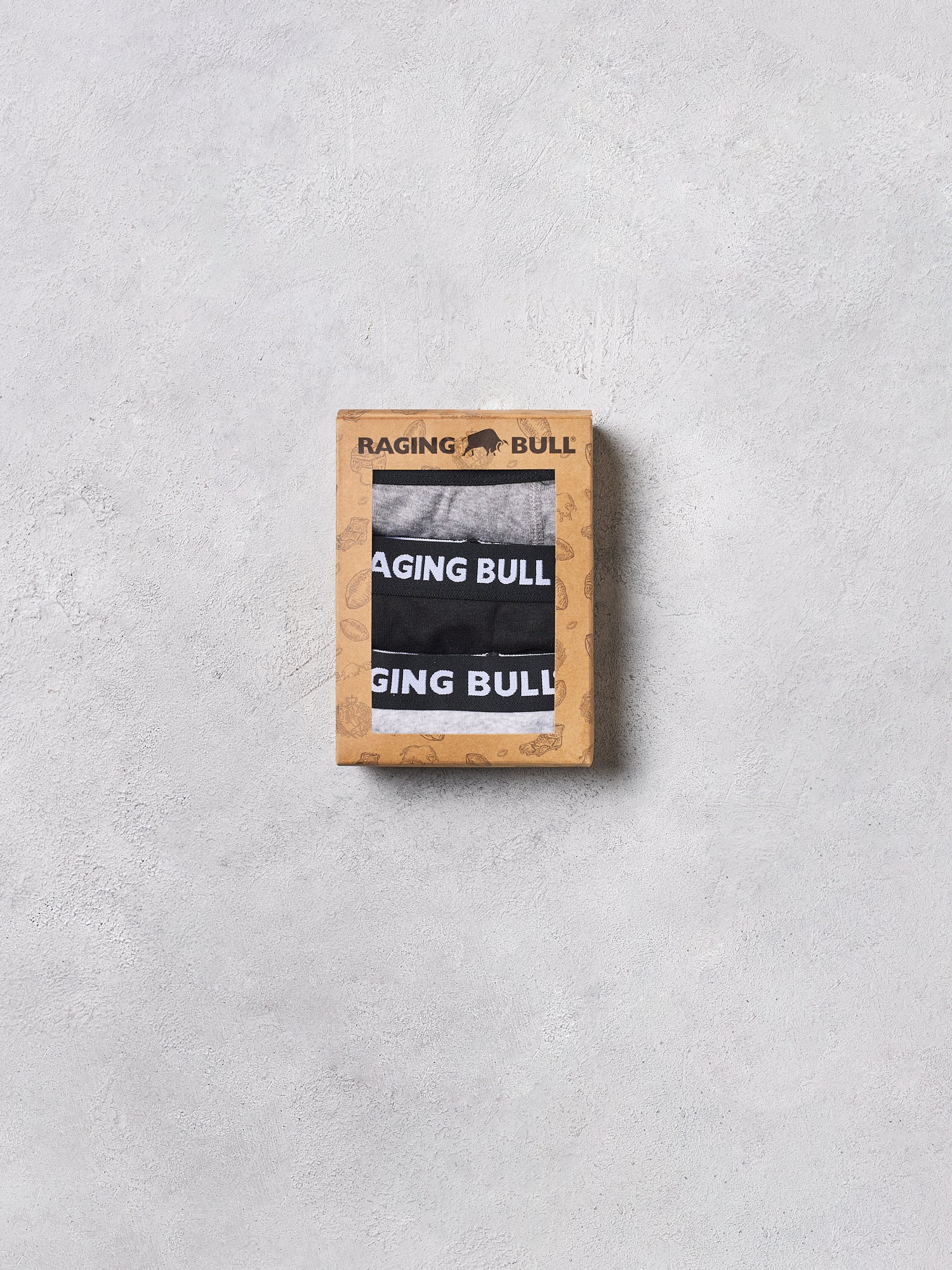 Raging Bull boxer briefs in a wooden box on a light gray background