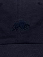 Close-up of navy blue cap with a small Raging Bull logo.