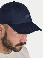 A man wearing a cap in navy blue
