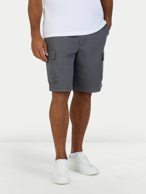 Person wearing gray cargo shorts on a white background