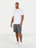 Man wearing a white t-shirt and gray shorts on a white background