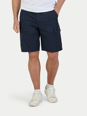 Person wearing navy cargo shorts on a white background