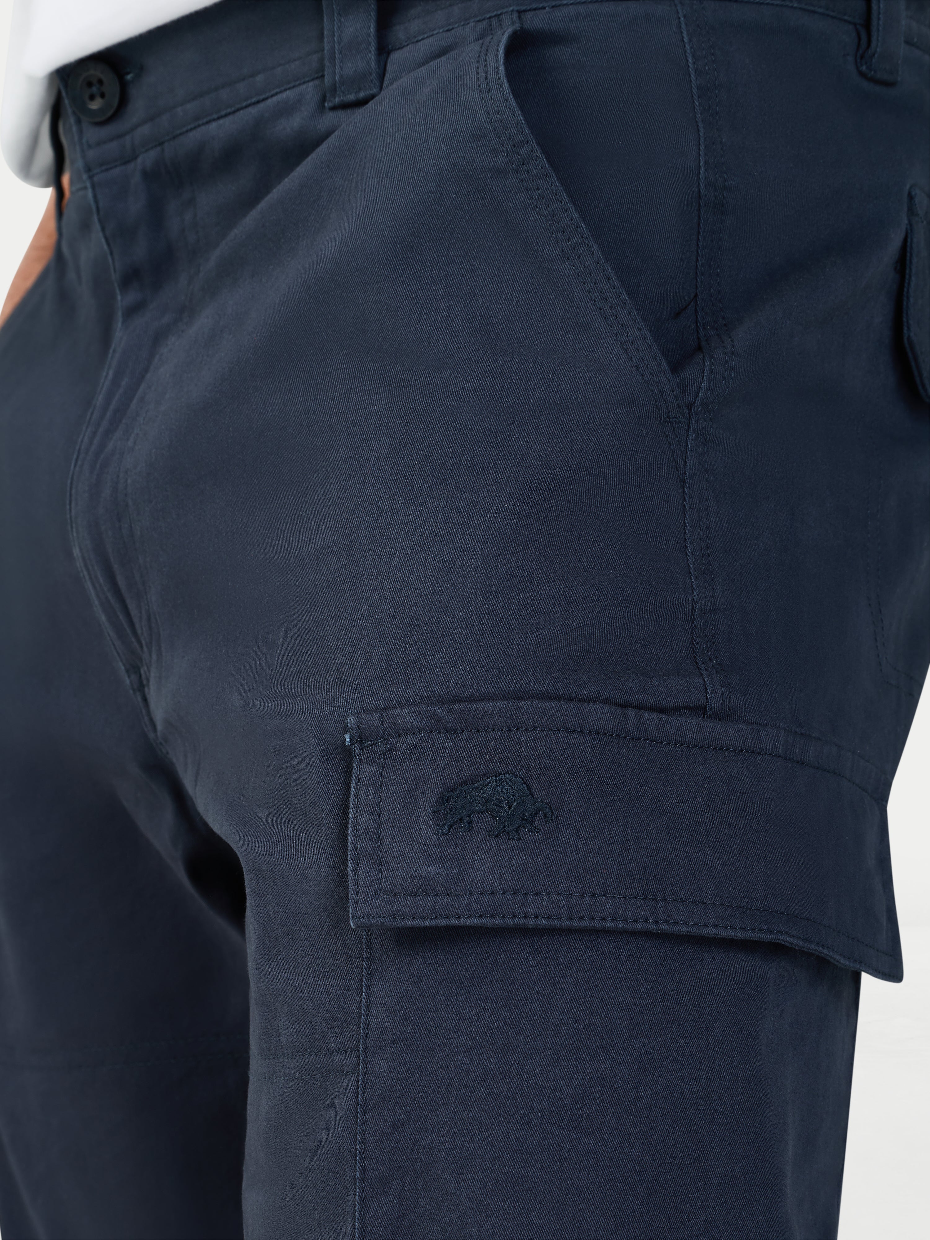 Navy blue cargo shorts with a Raging Bull logo on the pocket against a white background