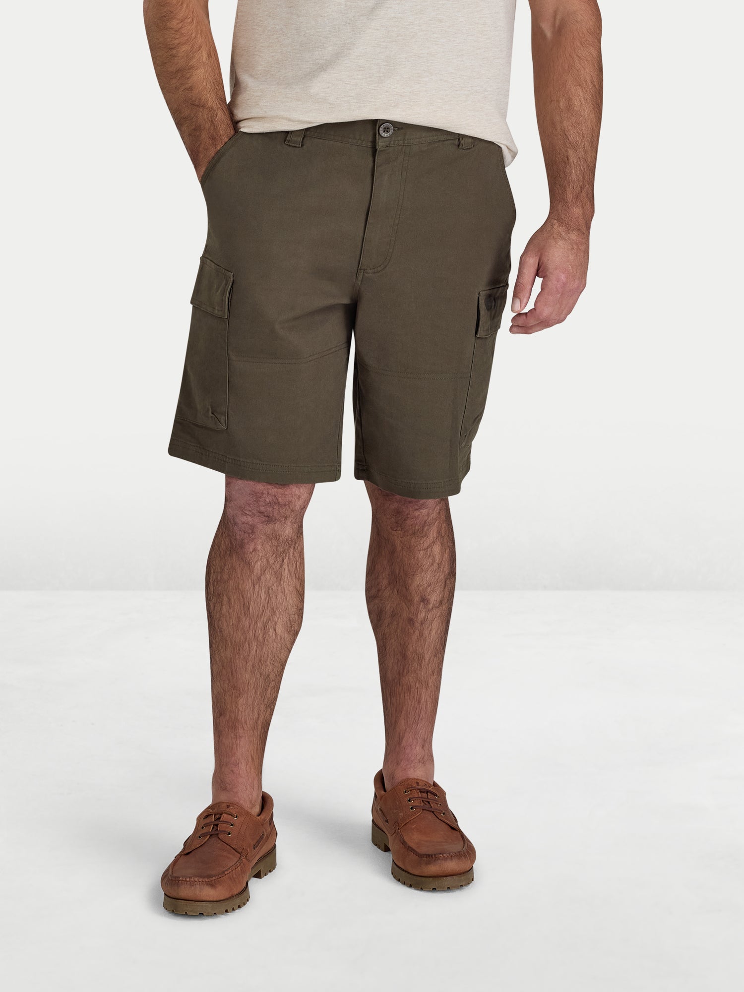 Person wearing olive green cargo shorts on a white background