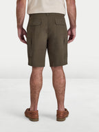 Person wearing olive green cargo shorts on a white background