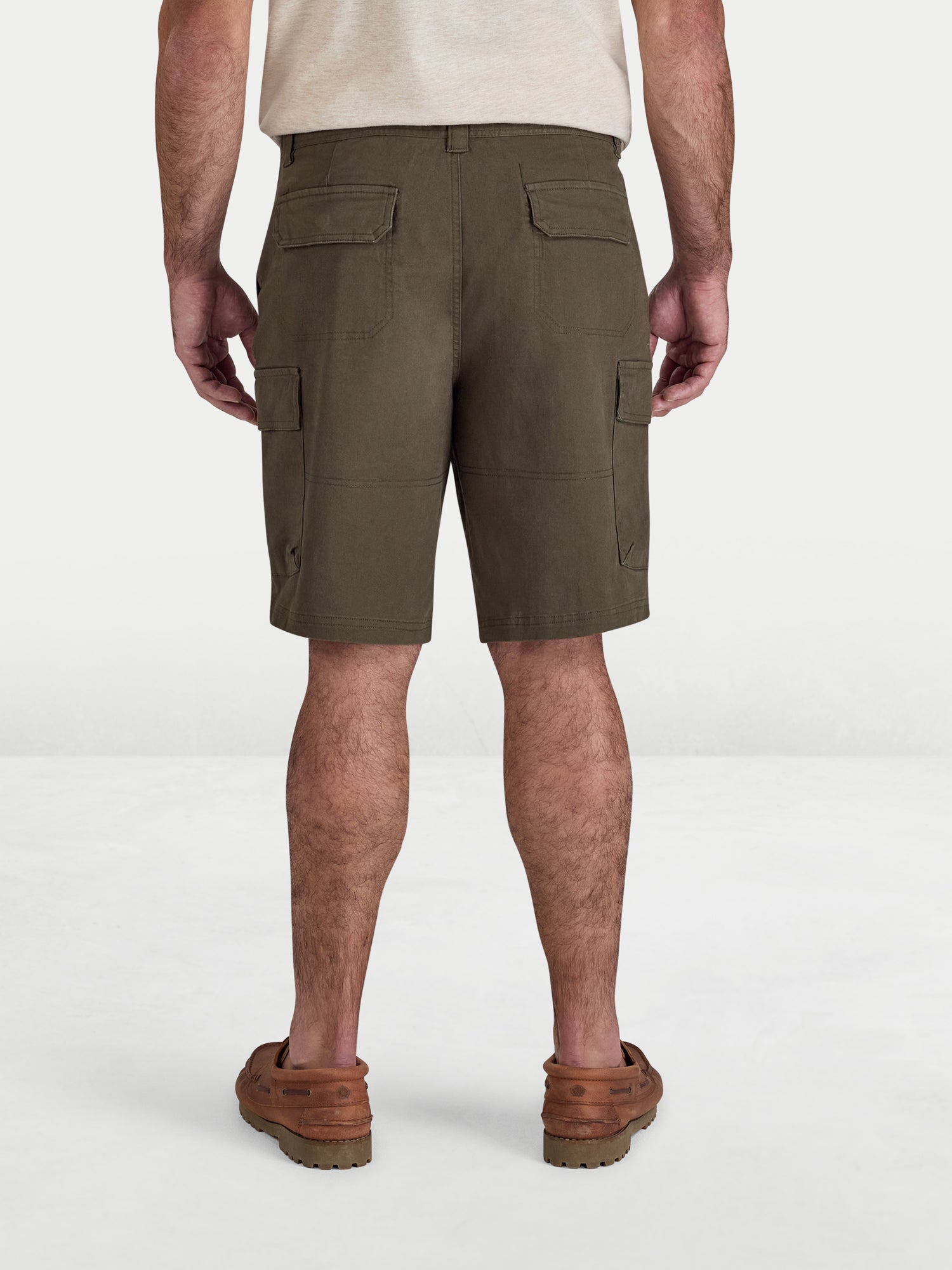 Person wearing olive green cargo shorts on a white background