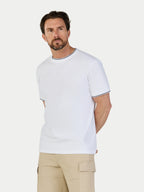 Man wearing a white t-shirt with black trim on a white background