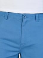 Close-up of blue pants with a white background
