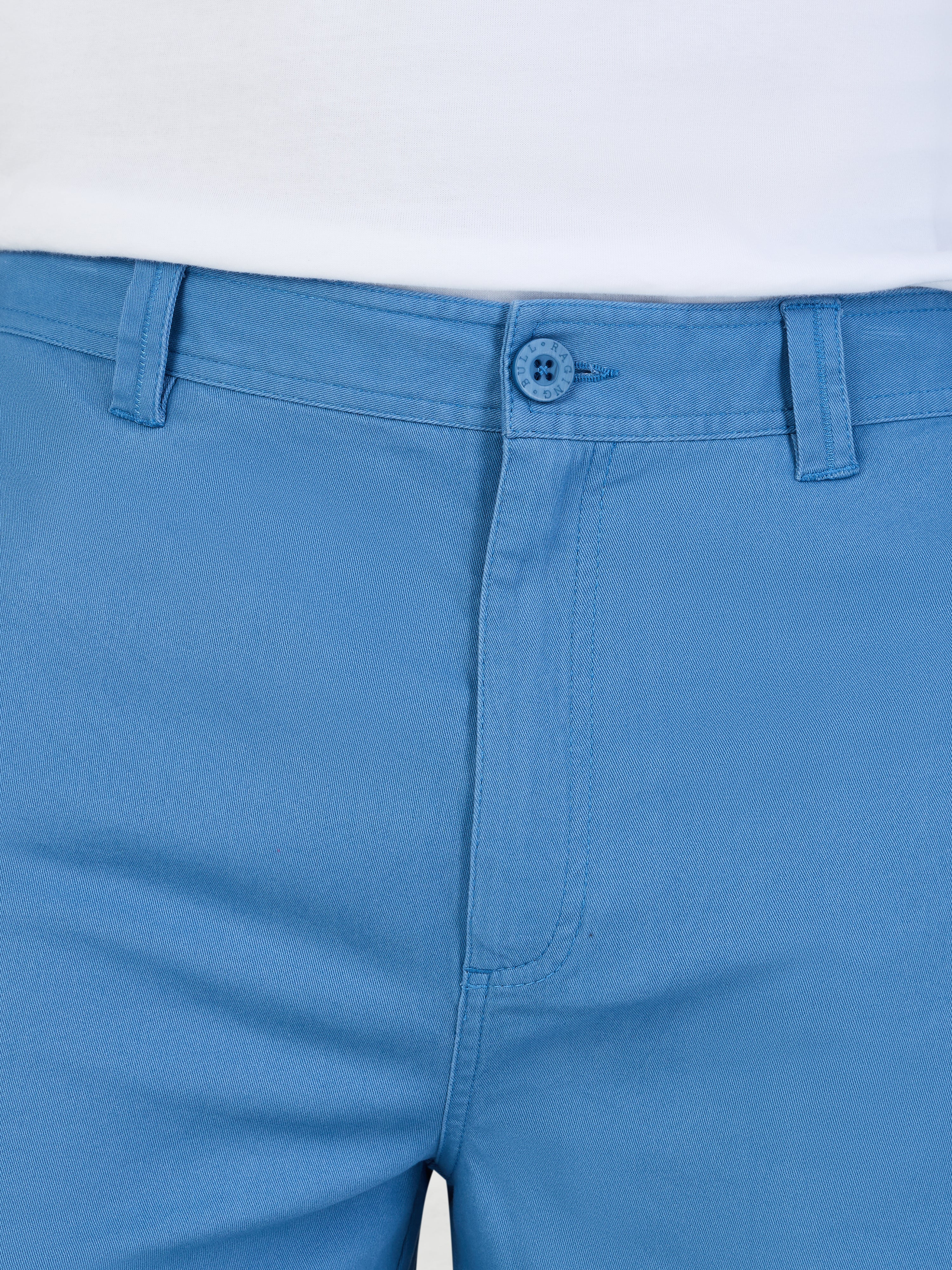 Close-up of blue pants with a white background
