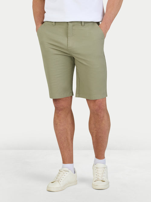 Man wearing classic chino shorts in sage. 
