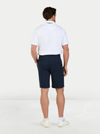 Man wearing Classic Chino Shorts in navy and Classic Polo Shirt in white, back.