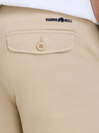 Beige shorts with a visible brand logo on the pocket