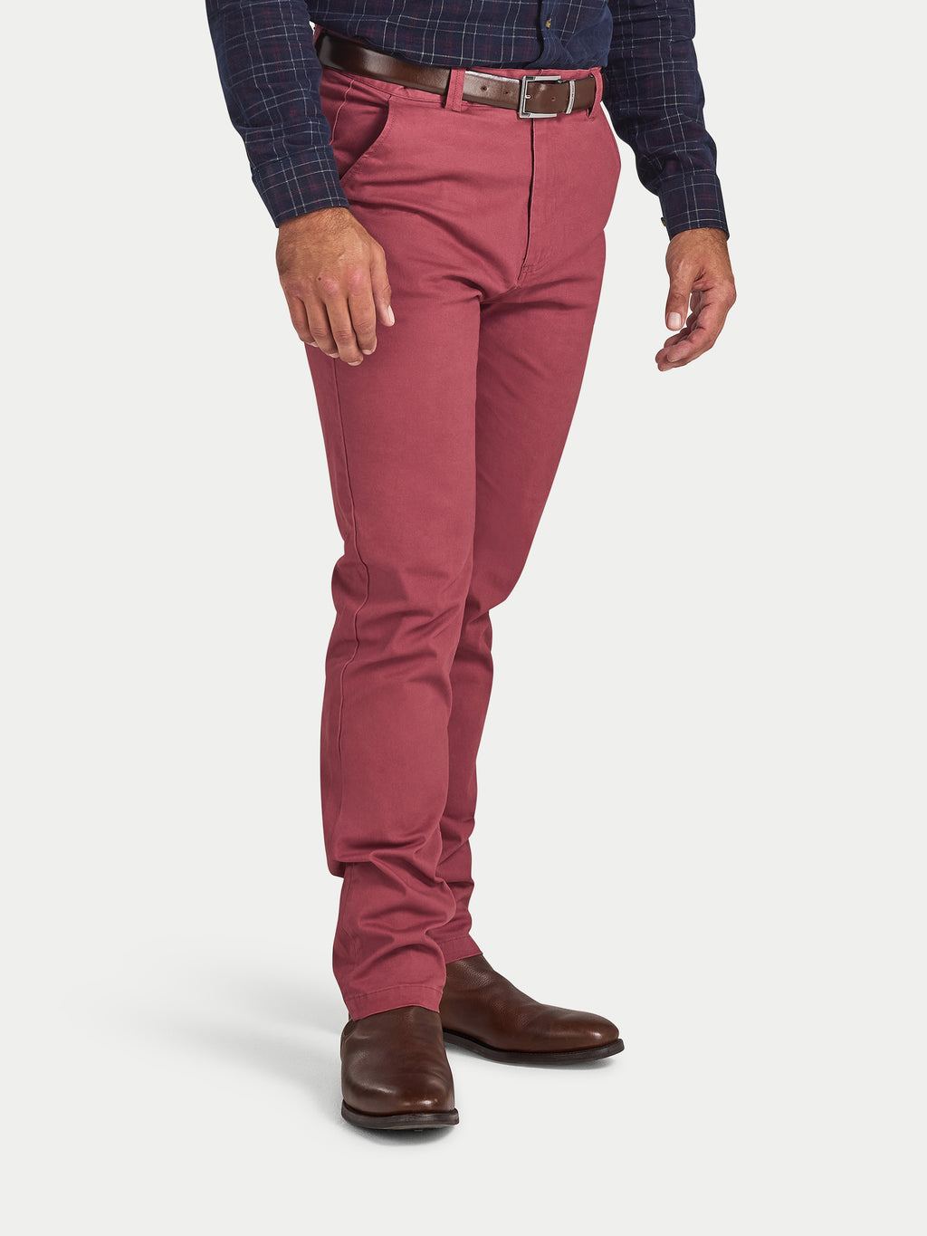 Person wearing red pants and a blue checkered shirt on a white background