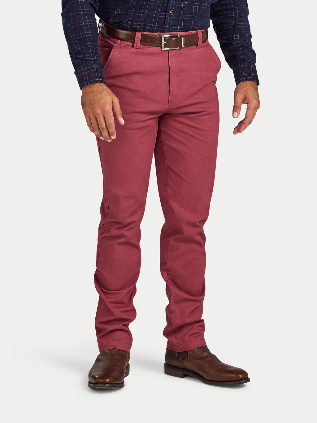Person wearing red pants and brown shoes on a white background