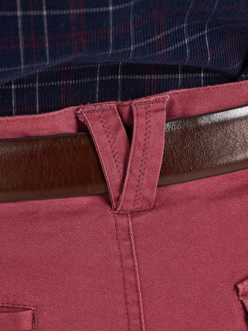 Close-up of a red belt with a plaid shirt in the background