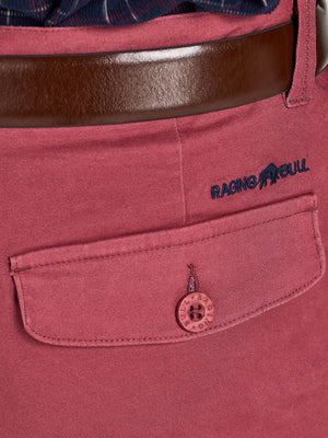 Close-up of a red shirt with a brown belt and 'Raging Bull' logo.