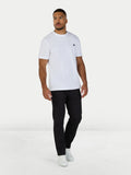 Man wearing a white t-shirt and black pants on a white background