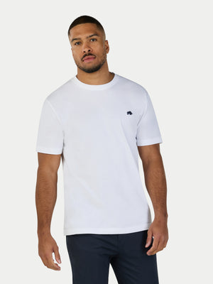 Man wearing a white t-shirt with a small logo on a white background