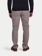 Person wearing gray pants and a black top on a white background
