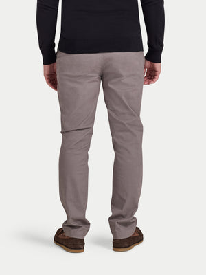 Person wearing gray pants and a black top on a white background