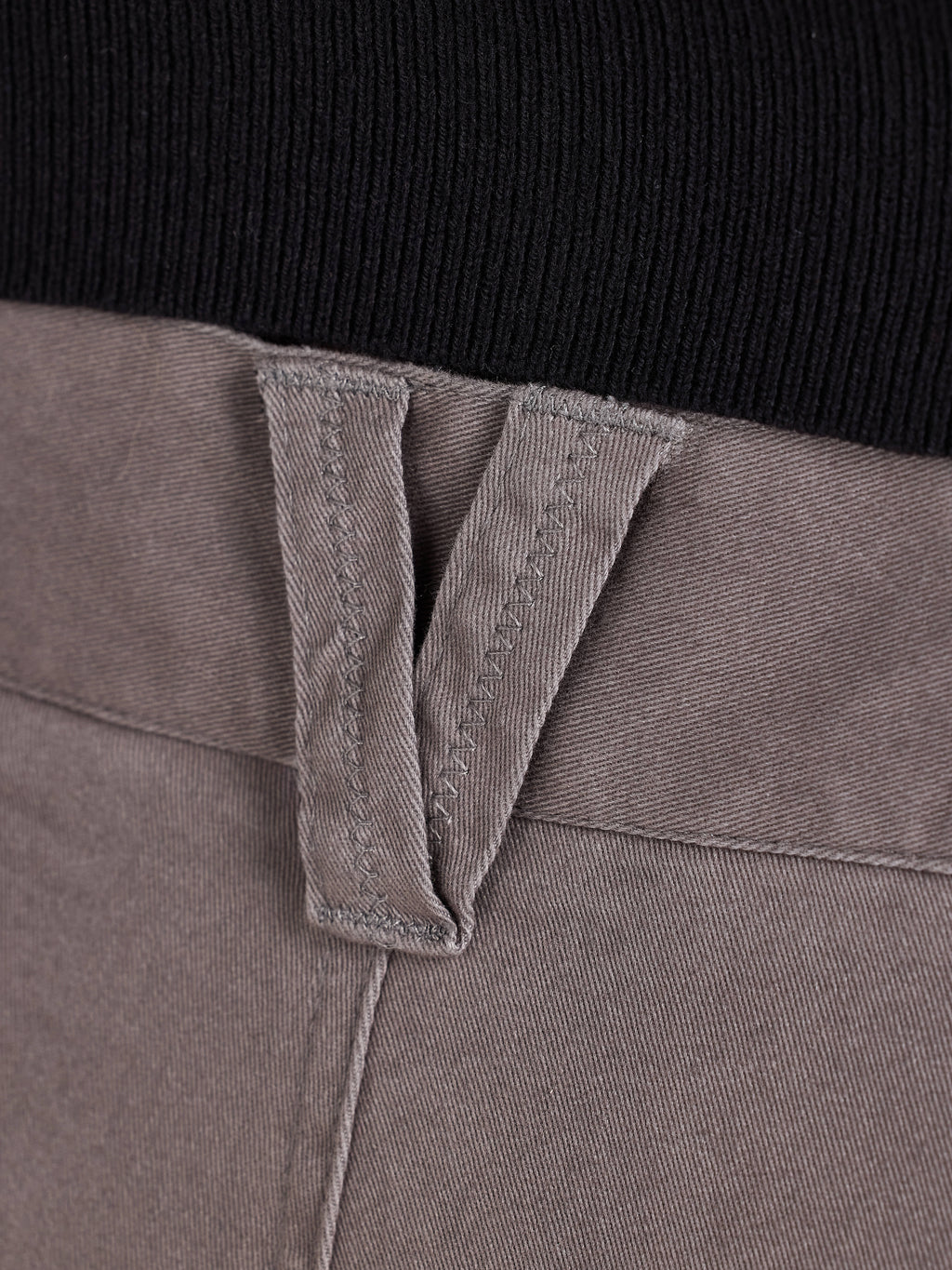 Close-up of a grey belt loop with a black background