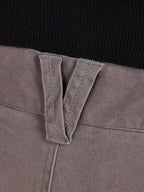 Close-up of a grey belt loop with a black background