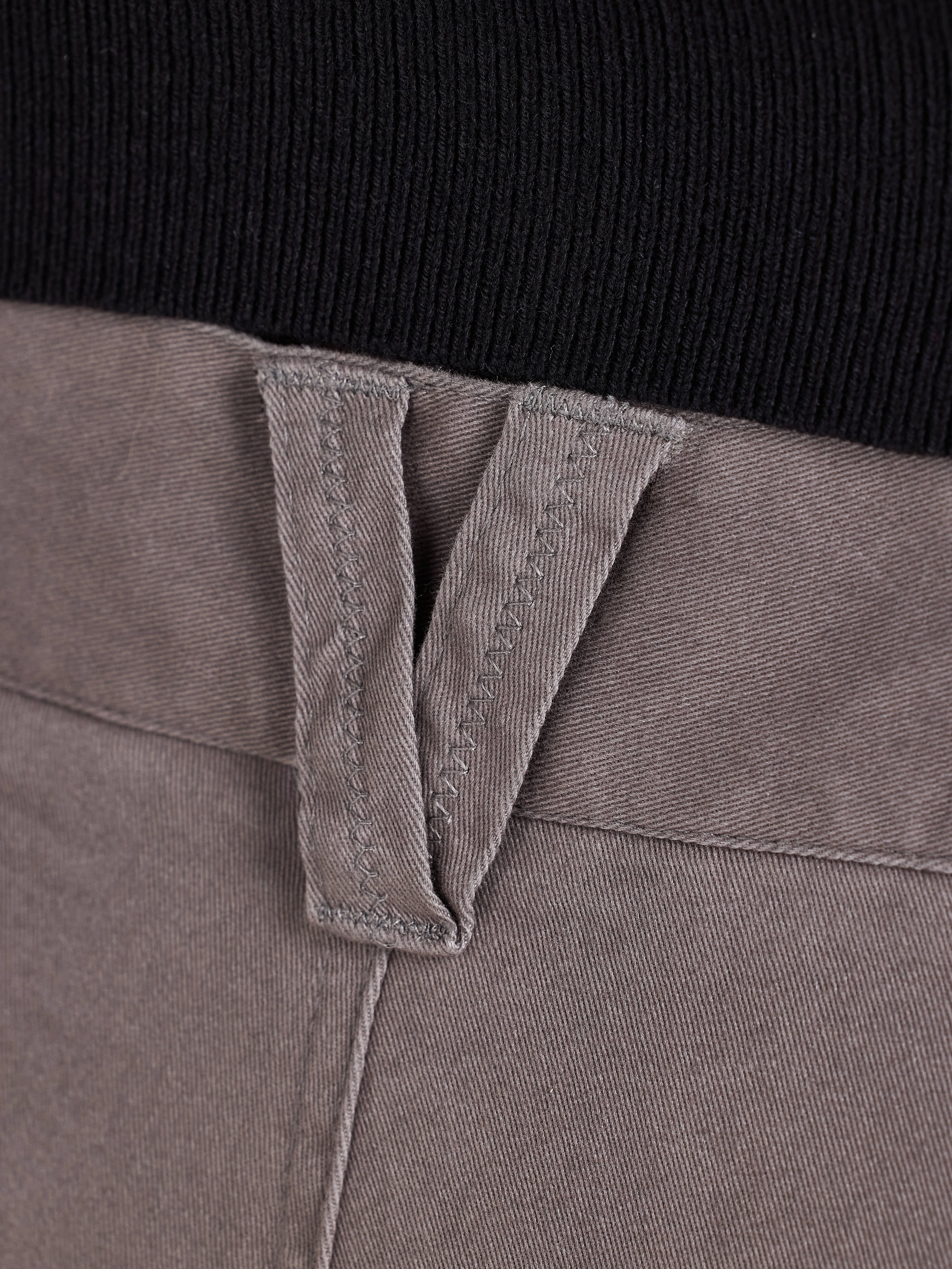 Close-up of a grey belt loop with a black background
