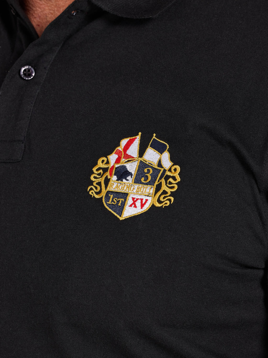 Black polo shirt with an embroidered crest on the chest