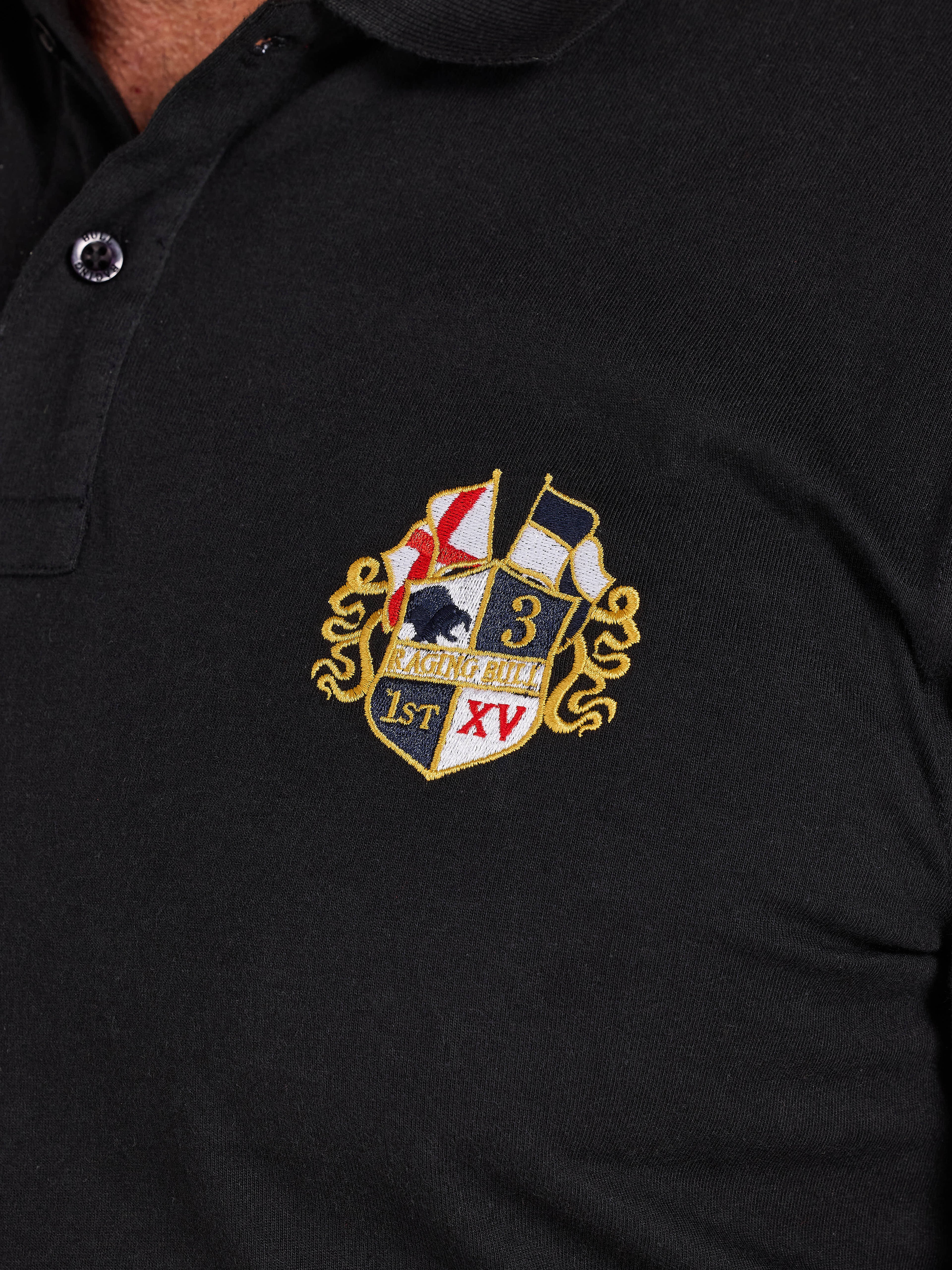 Black polo shirt with an embroidered crest on the chest