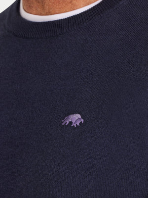 Navy sweater with a small purple logo on a plain background