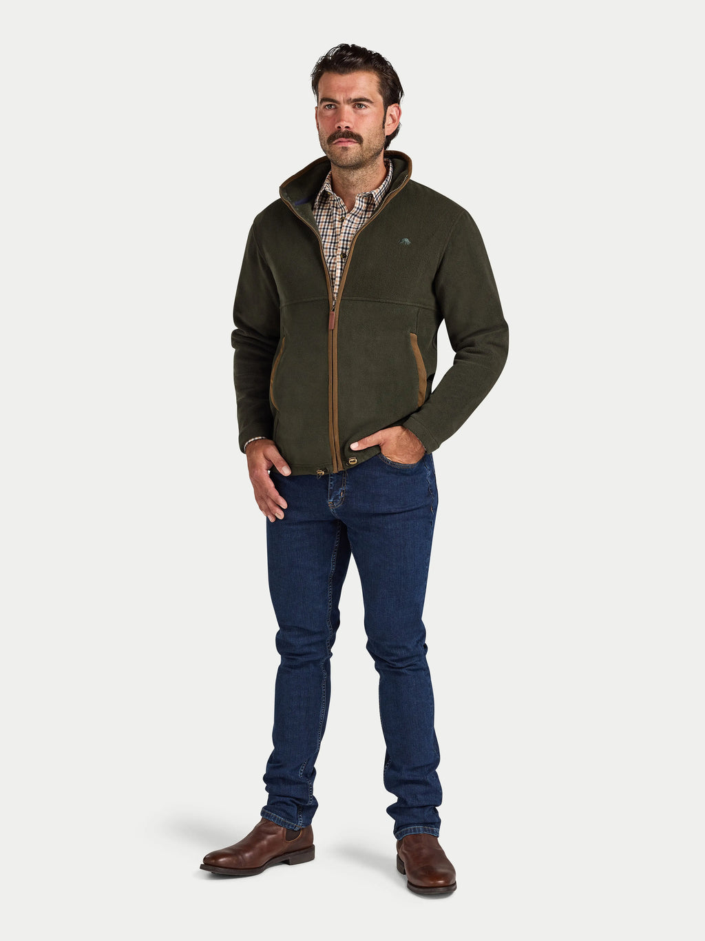Man wearing a green fleece jacket, plaid shirt, and blue jeans on a white background