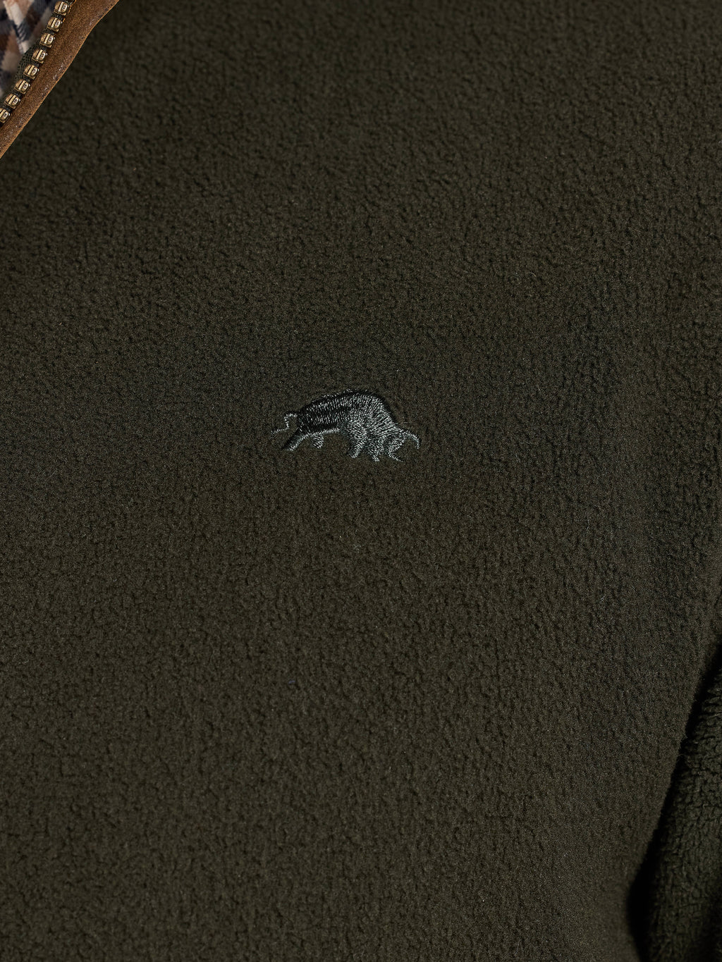 Close-up of a dark green fleece jacket with a Raging Bull logo on the chest.