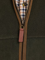 Close-up of a brown zipper on a green fleece jacket
