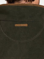 Close-up of a green fleece jacket with a brand logo on the chest.